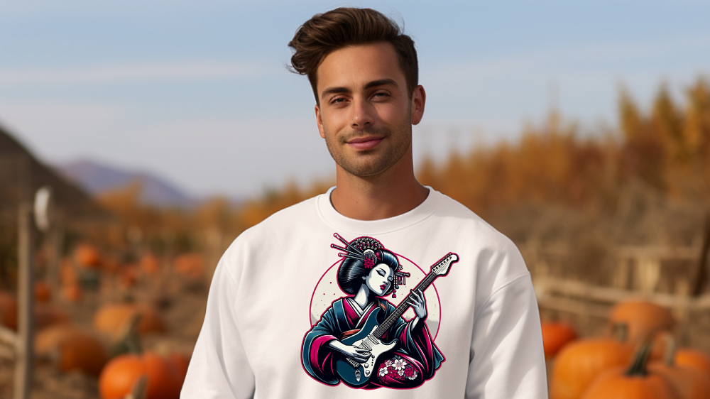 Man wearing a white sweatshirt with musical instrument print on the chest in a pumpkin field.